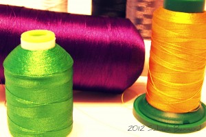 Purple, green, and gold thread